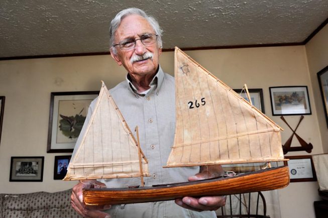 Frank White shows one of his model boats, 2012.