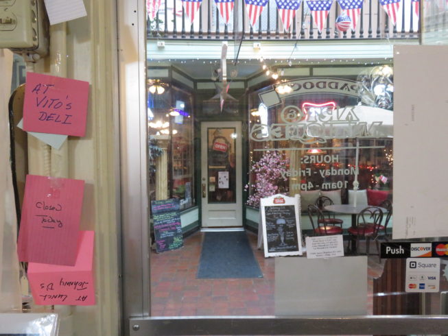 Lee Ellsworth and fellow proprietors of the Paddock Arts and Antiques store have notes at the ready for when they regularly step across the way to grab lunch from other businesses--and friends in their tight-knit community--in the Arcade. Photo by Camilla Ammirati, 2017.